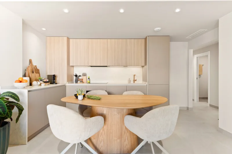 The fully fitted kitchen and round wooden dining table